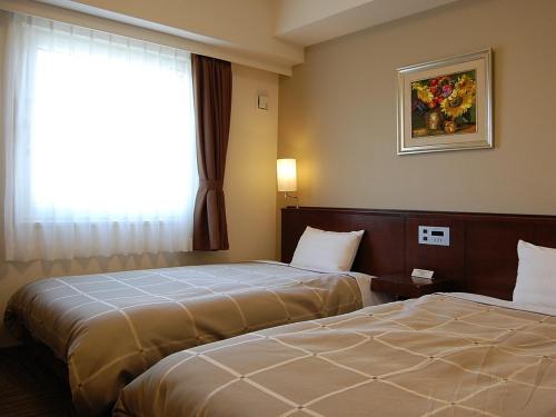 Postel nebo postele na pokoji v ubytování Hotel Route-Inn Nabari