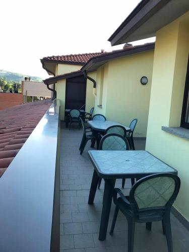 a group of tables and chairs on a patio at Hotel Ristorante Gallo D'Oro in Vignola