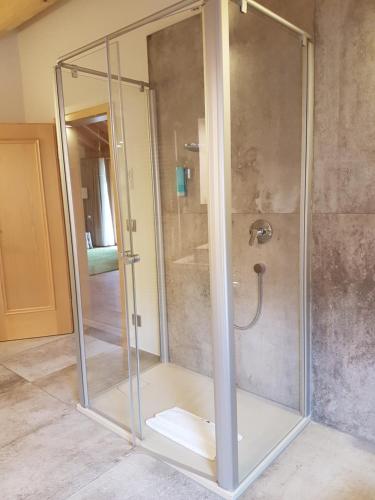 a shower with a glass enclosure in a bathroom at Gästehaus der Geroldsauer Mühle in Baden-Baden
