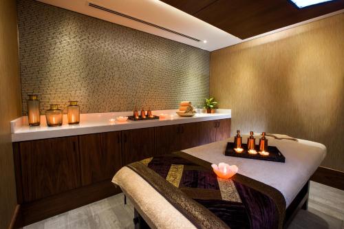 a bathroom with a table and a bath tub at Ayla Grand Hotel in Al Ain