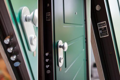 a close up of a green door with silver handles at Casa Leoma in Alassio