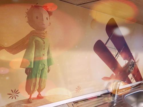 a plastic doll in a window next to a sink at Apartmány Malý Princ in Bojnice
