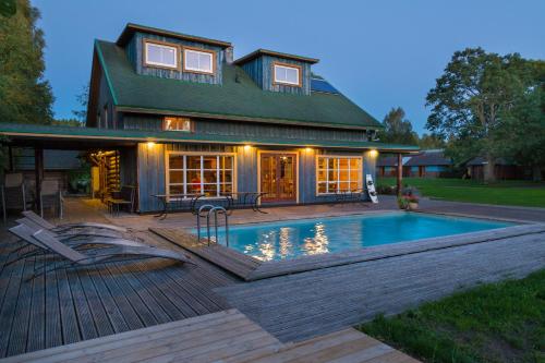 a house with a swimming pool in front of a house at Tuisuliiva Holiday House in Kabli
