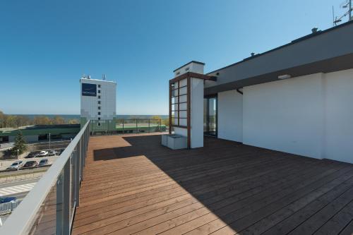 a deck on a building with a view at INA Rent - Tre Mare Apartamenty in Gdańsk