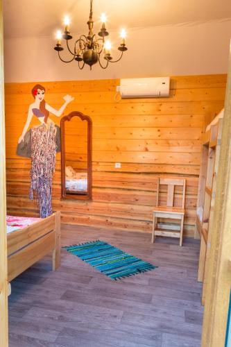 a room with a mirror and a woman in a dress at Tuisuliiva Holiday House in Kabli
