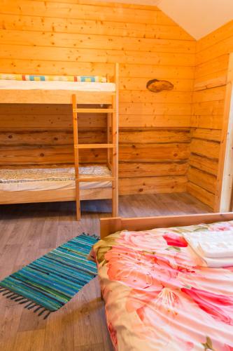 a bedroom with two bunk beds and a ladder at Tuisuliiva Holiday House in Kabli