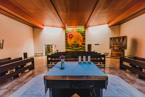 a church with benches and a painting on the wall at Bildungshaus St. Hippolyt in Sankt Pölten