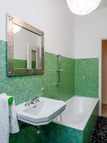 a bathroom with a sink and a mirror at Enjoy Apartment Gorla in Milan