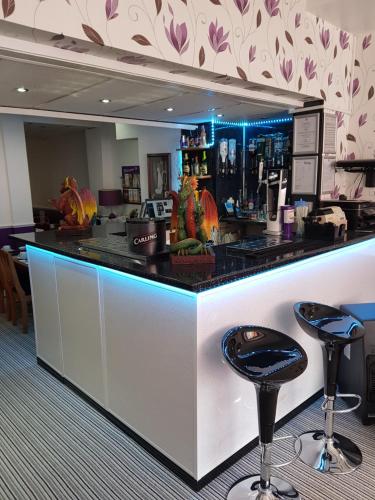 a bar with a counter with two stools at The Trentham Hotel in Blackpool