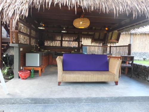 a chair with a purple cushion sitting on a patio at Uma Nirmala Aling-Aling in Singaraja