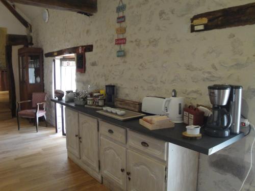 a kitchen with a counter with a coffee maker on it at La Ferme du Vintué in Étréchy