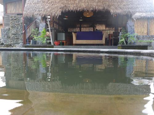 a pool of water in front of a building at Uma Nirmala Aling-Aling in Singaraja