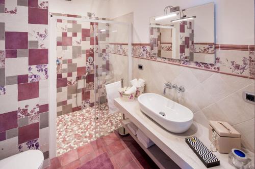 a bathroom with a white sink and a shower at Casa Leoma in Alassio