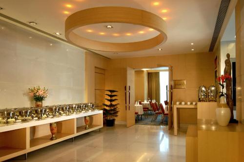 a large room with a restaurant with a large ceiling at Radisson Mumbai Goregaon in Mumbai