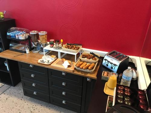 a counter with various pastries and desserts on it at Hotel De L'Europe in Toul
