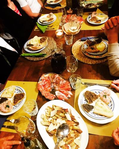 a wooden table with plates of food on it at Podere Terreno alla via della volpaia in Radda in Chianti