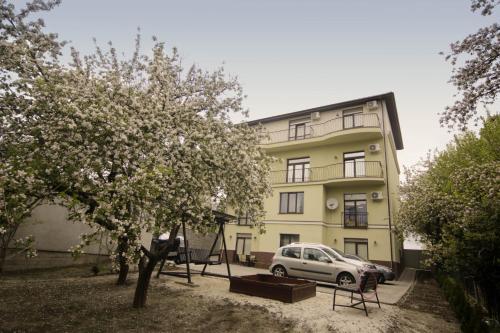 a white car parked in front of a building at Potocki Apartments in Lviv