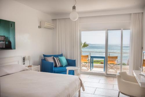 a bedroom with a bed and a view of the ocean at Sideratos Apartments in Karfas