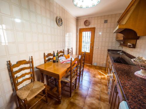 a kitchen with a wooden table and chairs in it at Bunyola in Bunyola