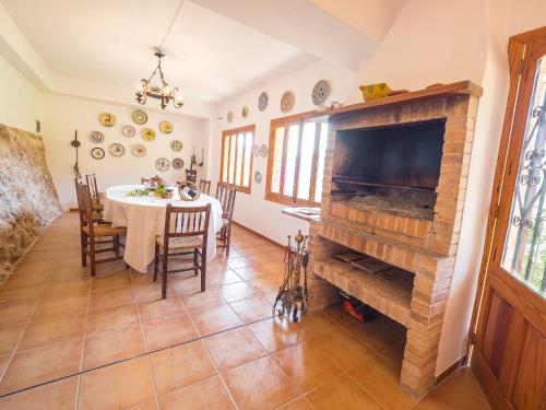 a dining room with a table and a fireplace at Bunyola in Bunyola
