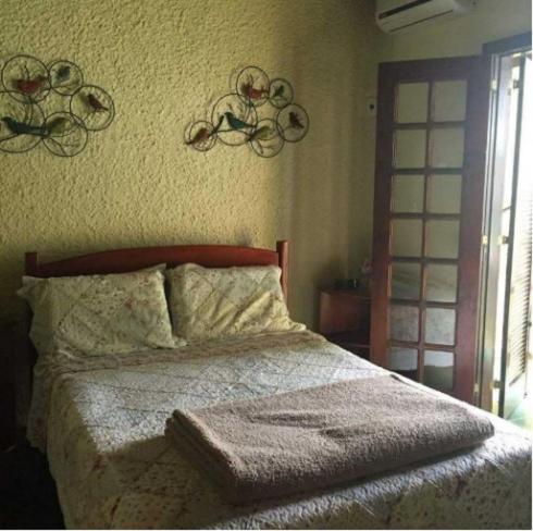 a bedroom with a bed and a wall with bike decorations at Pousada Alto da Pontinha in Araruama