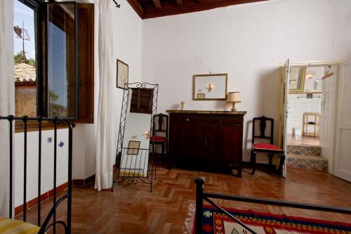 a living room with a wooden floor and white walls at Palazzo Forani in Casperia