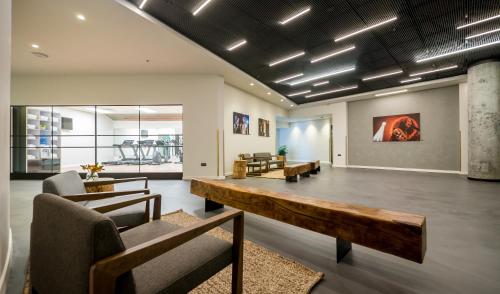 a lobby with a table and chairs and a couch at La Cappella Business Boutique Hotel in Haifa