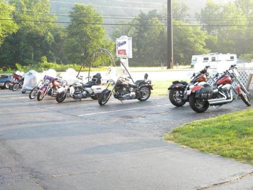 a row of motorcycles parked in a parking lot at Clarketon Motel - Maggie Valley in Maggie Valley