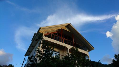 a tall building with a blue sky in the background at Skyline View in Bel Ombre