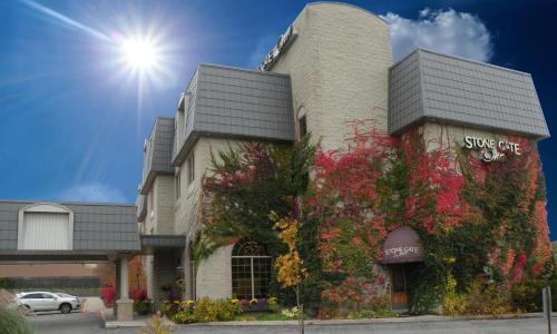 a building with flowers on the side of it at Stone Gate Inn in Orillia