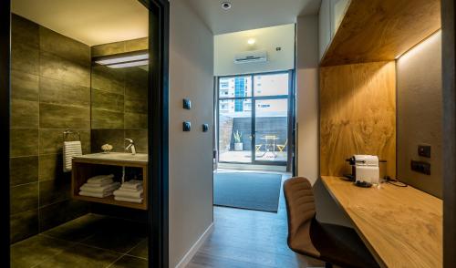 a bathroom with a sink and a mirror at La Cappella Business Boutique Hotel in Haifa