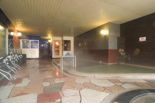 a swimming pool in a large room with a pool at Hotel Grand Toya in Lake Toya