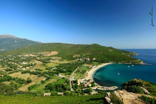 an aerial view of a small island in the ocean at Hôtel U Pozzu in Sisco