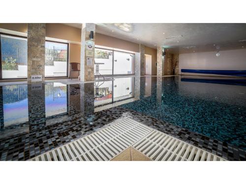 a room with a swimming pool with glass floors at Park Hotel and SPA Vella Hills in Velingrad