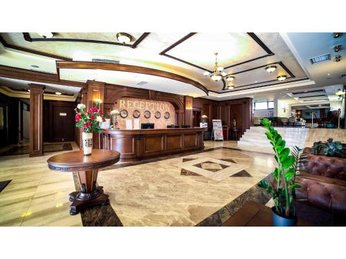 a lobby with a table with flowers on it at Park Hotel and SPA Vella Hills in Velingrad