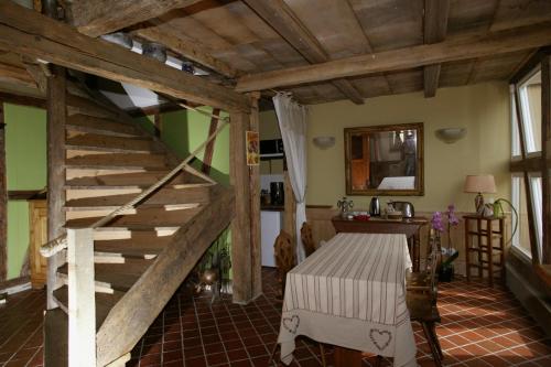 a room with a wooden staircase and green walls at Chambres d'Hôtes La Stoob Strasbourg Sud in Illkirch-Graffenstaden