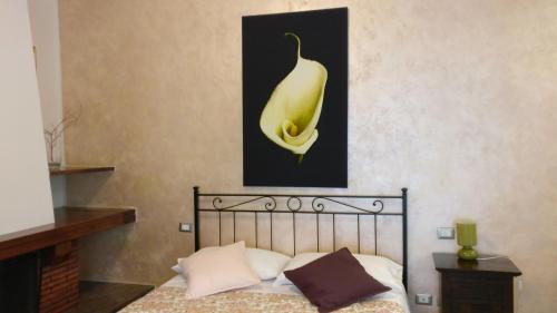 a bedroom with a bed with a picture of a banana at Casamare Hotel in San Vincenzo