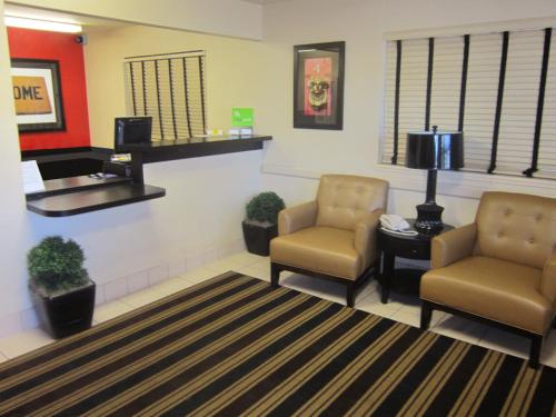 a waiting area with two chairs and a waiting room at Extended Stay America Suites - Sacramento - Arden Way in Sacramento