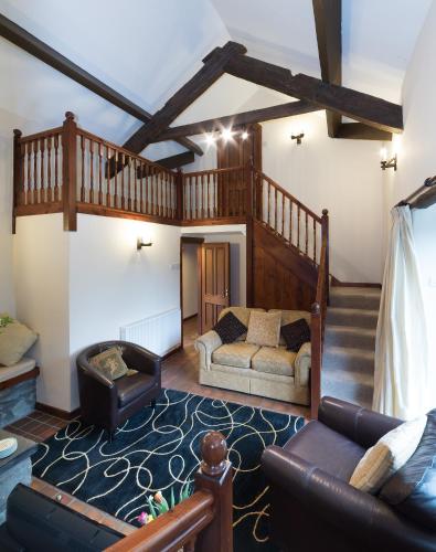 a living room with a couch and a staircase at Conwy Valley Cottages in Conwy