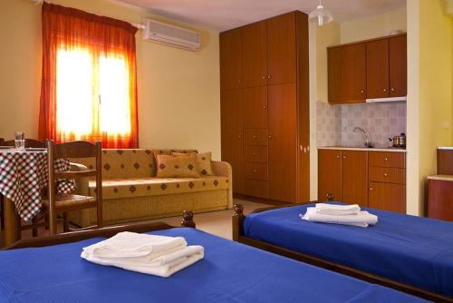 a living room with two beds and a couch at Evangelia in Ayia Evfimia