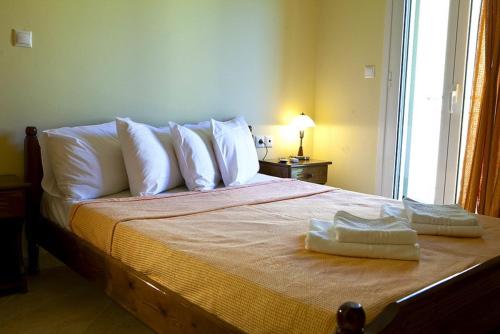 a bedroom with a bed with two towels on it at Evangelia in Ayia Evfimia