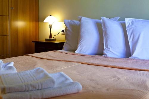 a bedroom with a bed with white towels on it at Evangelia in Ayia Evfimia