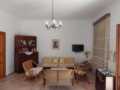 a living room with a couch and a table and chairs at Kaina Villa in Vamos