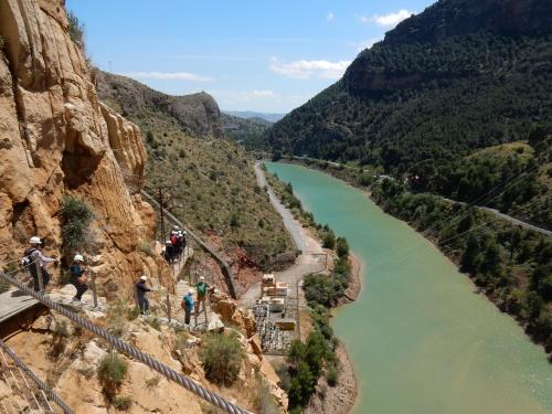 a group of people standing on a suspension bridge over a river at Hotel Antequera Rural Fortes La Nuit in Mollina