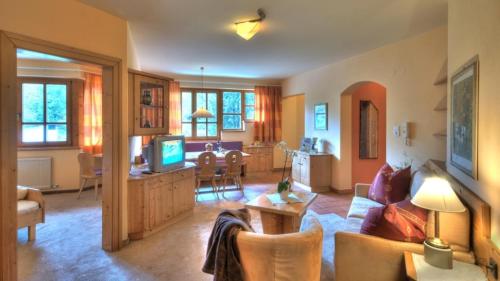 a living room with a couch and a dining room at Alt Mösern in Seefeld in Tirol