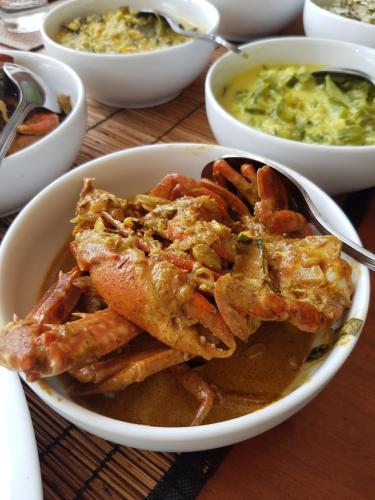 a bowl of food with shrimp and a bowl of soup at Wellé Wadiya Beach Villa in Kalpitiya