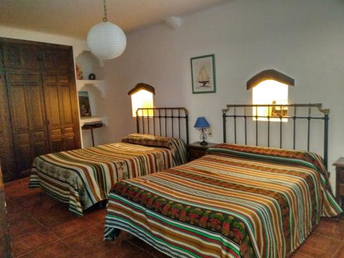 A bed or beds in a room at Casas Rurales Encarnita
