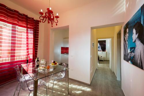 a dining room with a glass table and chairs at Cineholiday House 1 in Castellammare del Golfo