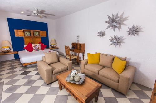 a living room with a couch and a bed at Casa Natalia Boutique Hotel Adults Only in San José del Cabo