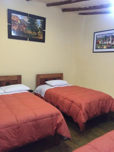 Postel nebo postele na pokoji v ubytování Rumi Sonqo Hostel